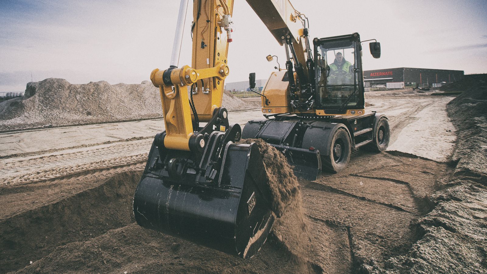 M318 Excavator picking up dirt on jobsite