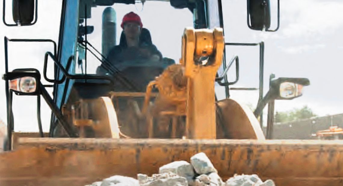 Operator hauling rock