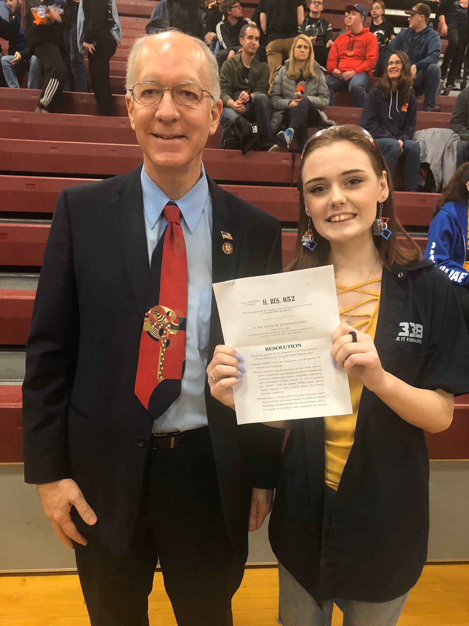 U.S. Congressman Bill Foster with a team member sharing House Resolution #942