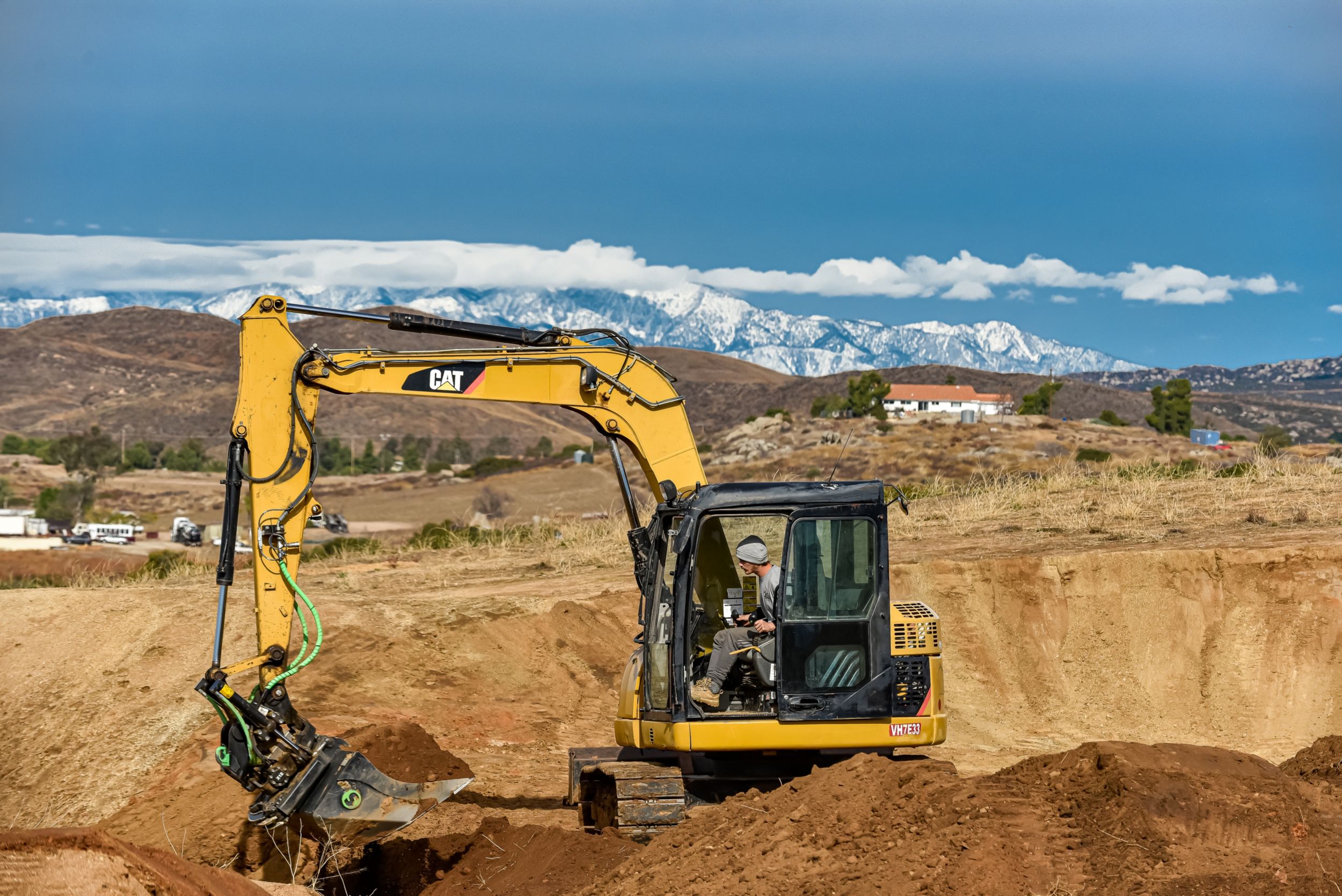 Jarryd McNeil Motocross athlete operating a Cat excavator at his home.