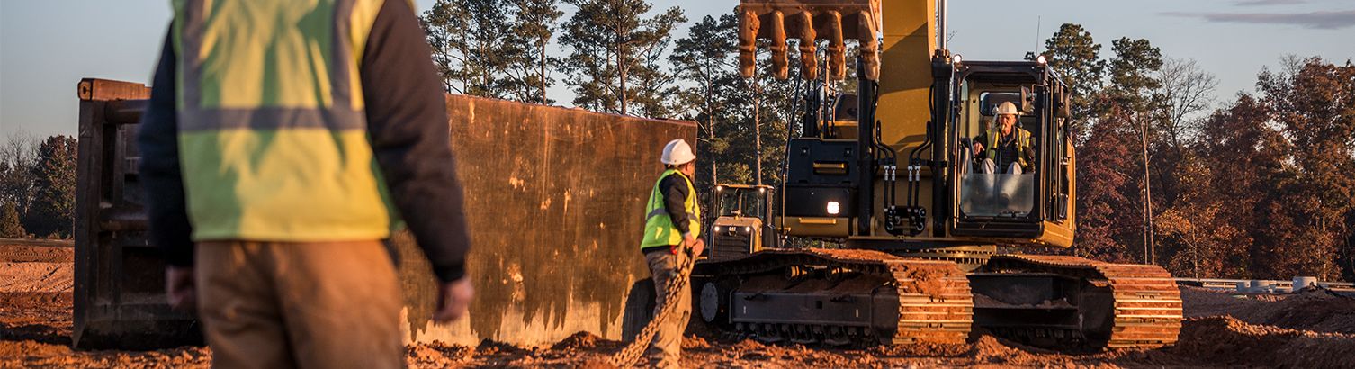 Excavator and workers on construction site