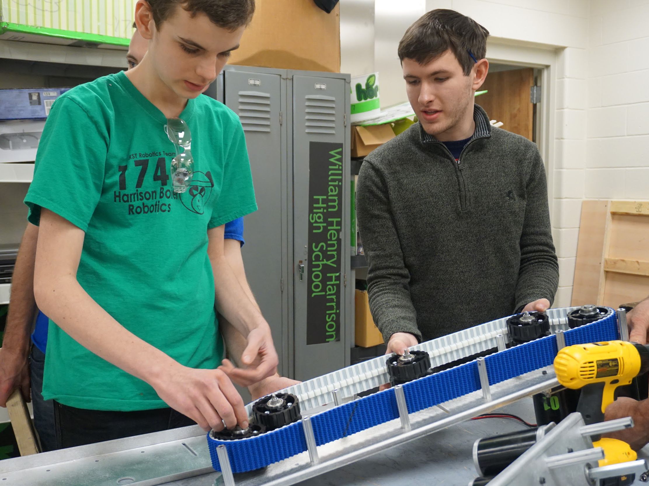 2 boys working on a robot