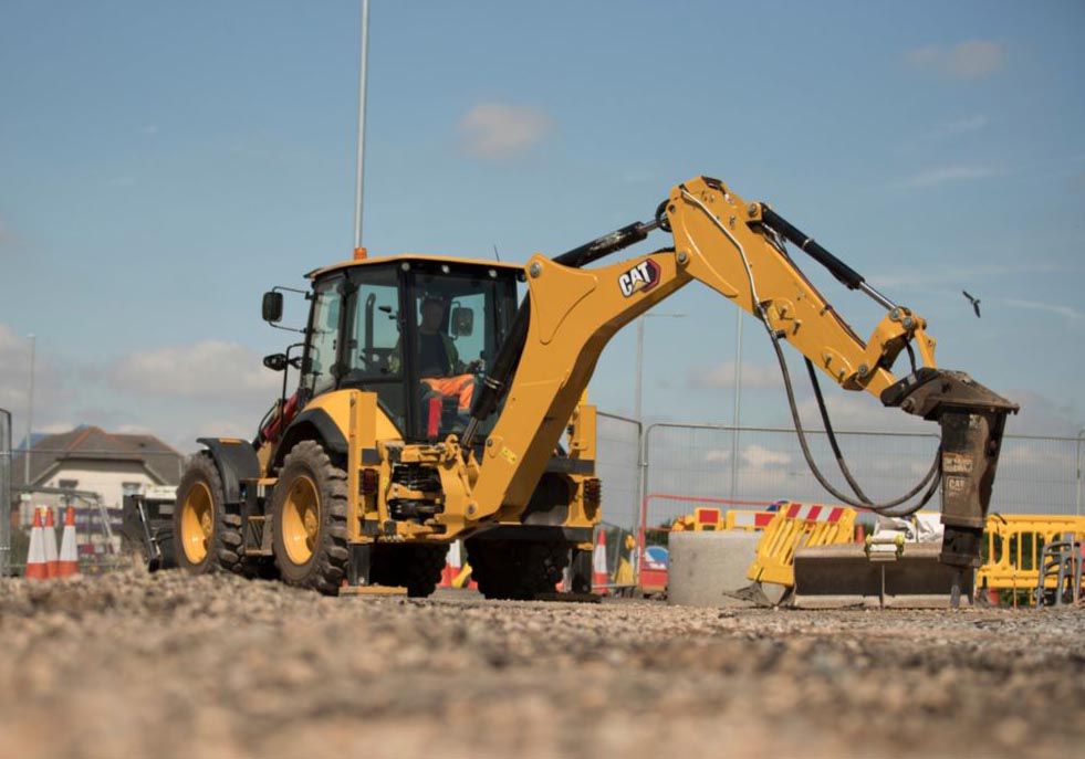 A wheel loader lifting a load of timber