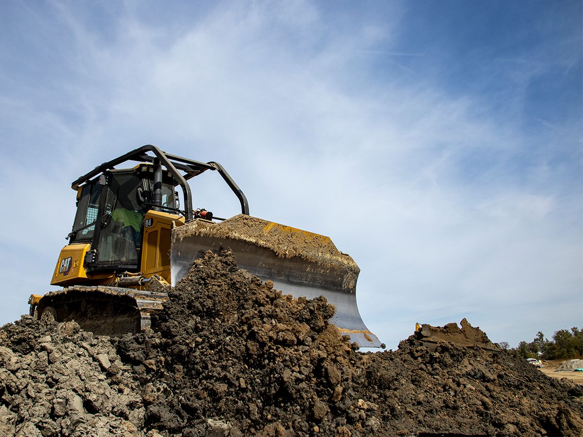 D4 bulldozer filling a trench after underground utility installation