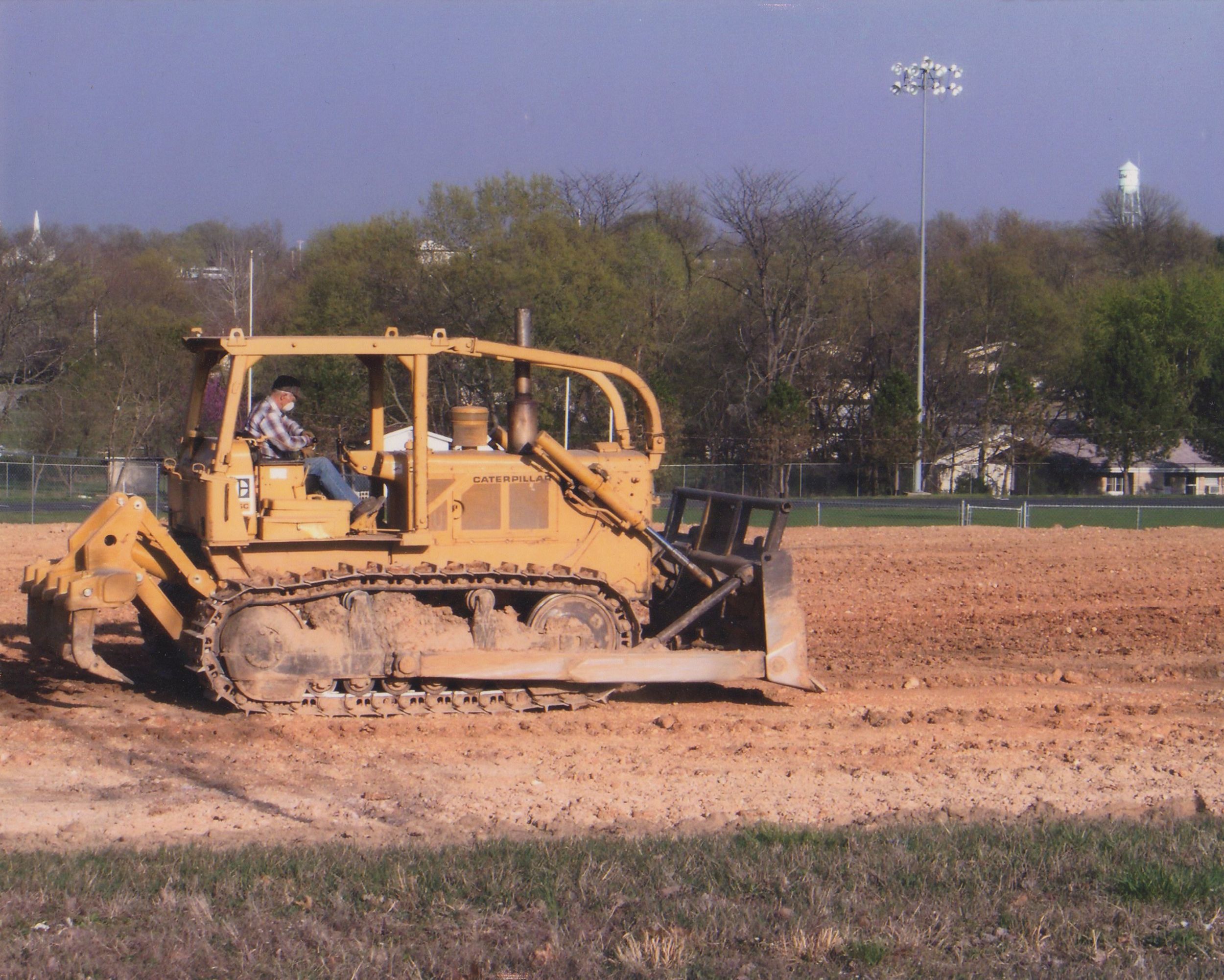KW Nichols On Bulldozer Building High School Practice Field