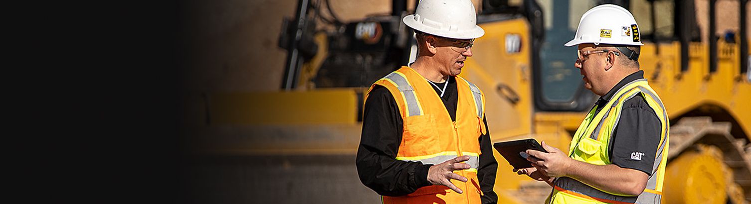 2 operators in front of machine