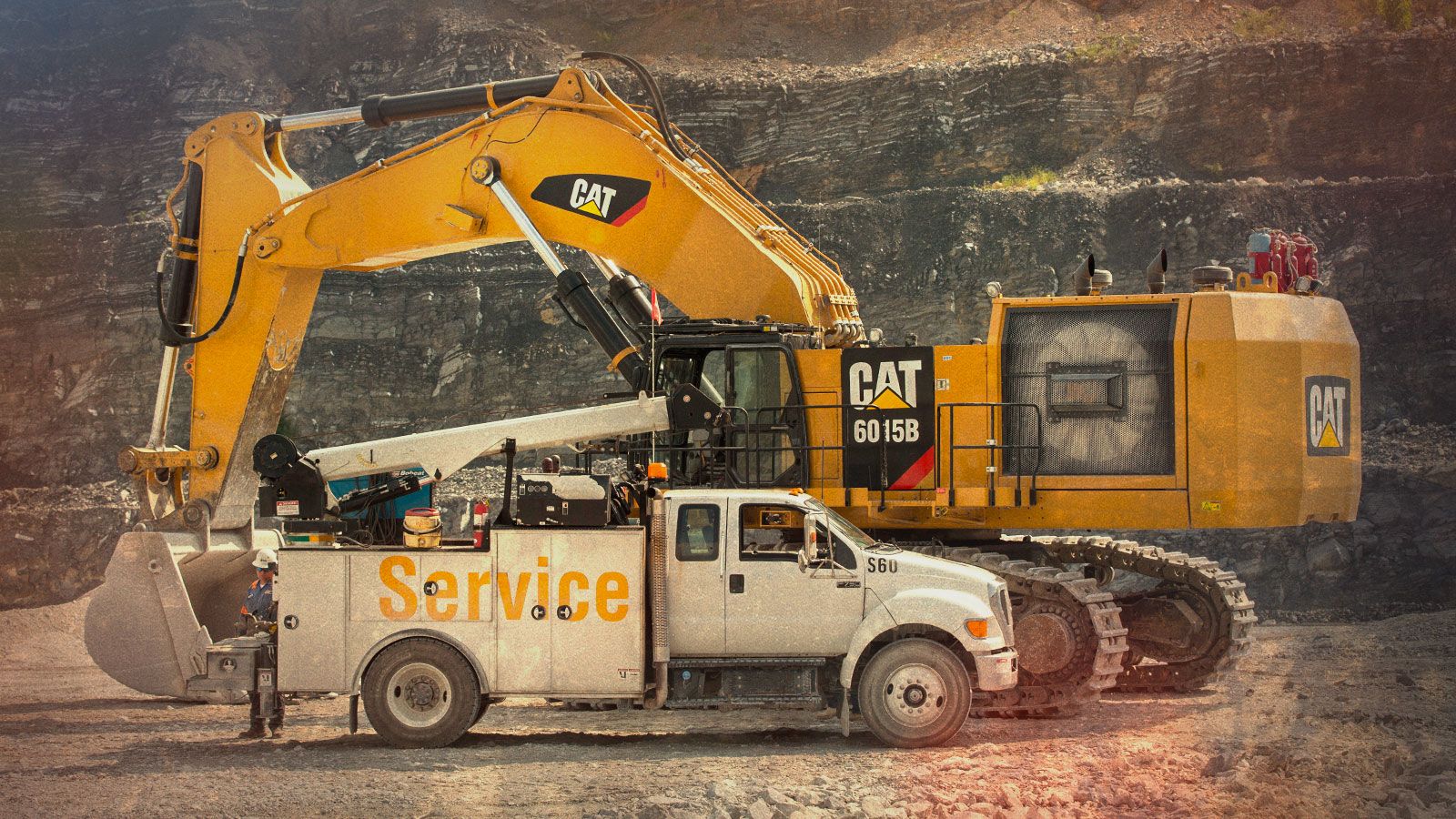 Camión de servicio averiado cerca de una excavadora grande