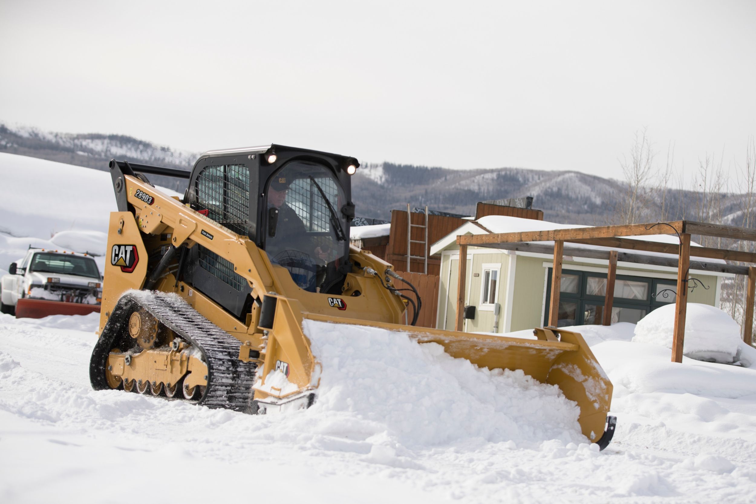 Cat 289D3 Compact Track Loader pushing snow