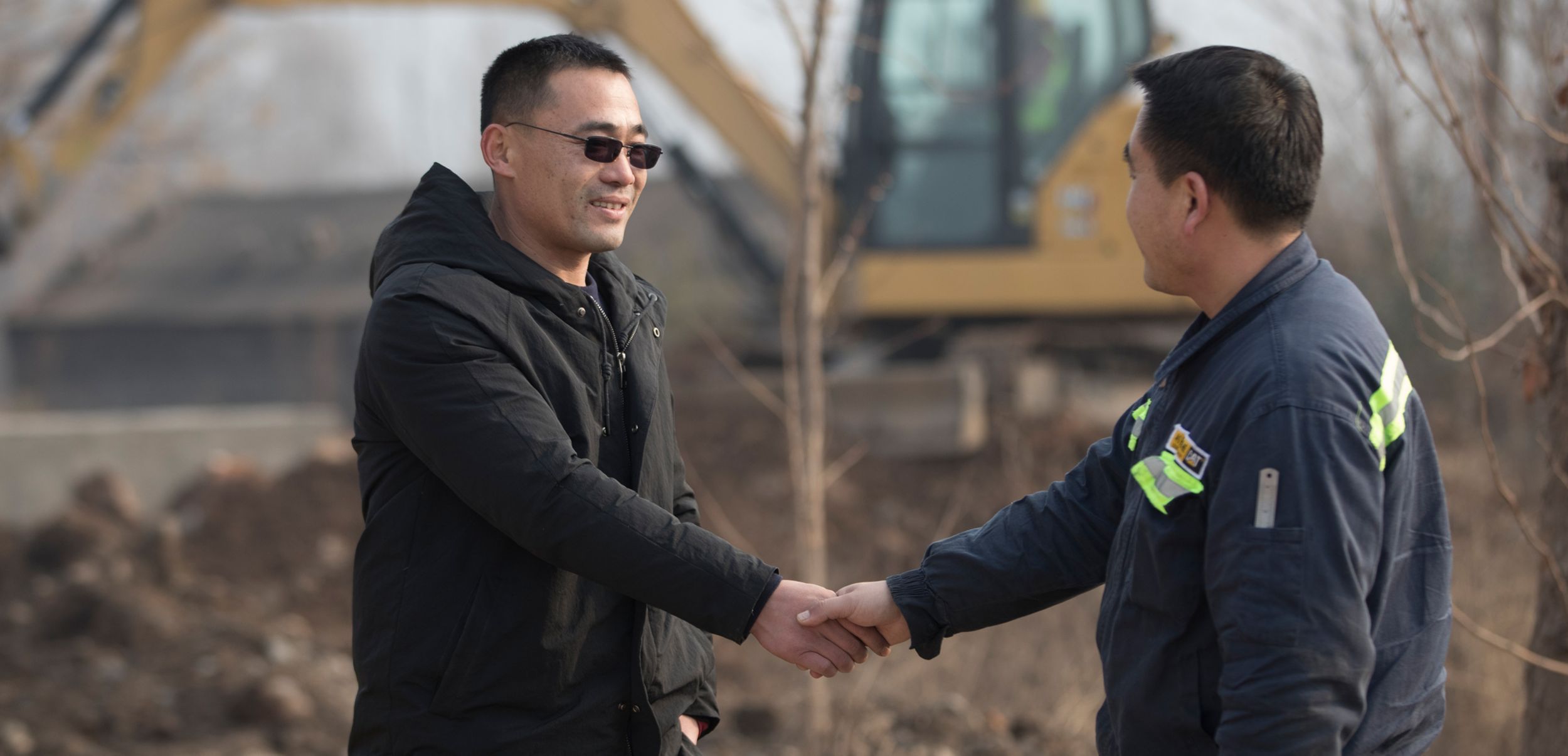 two men shaking hands at a jobsite