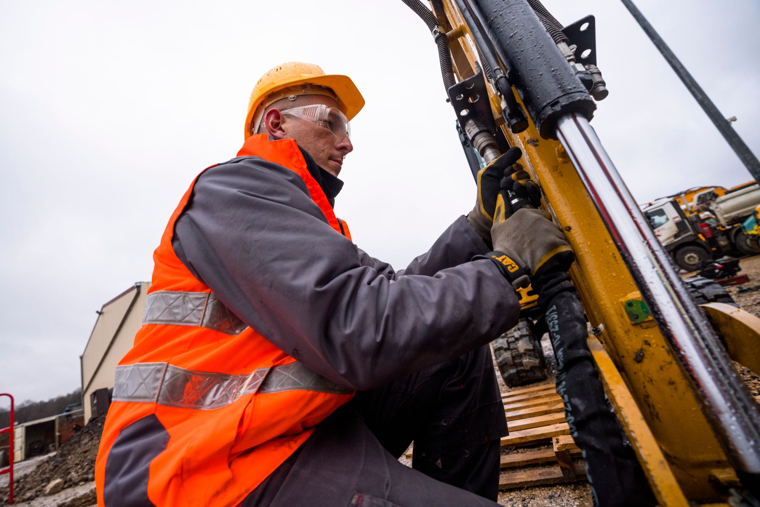 Cat worker performing maintenance on machine