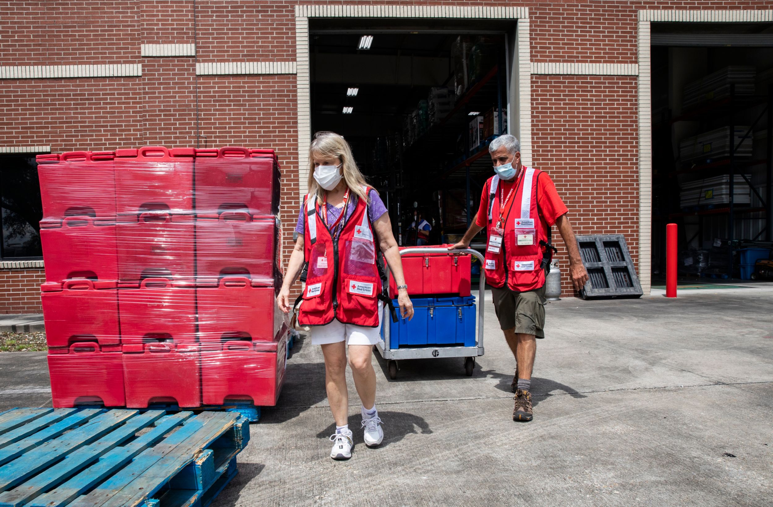August 28, 2021. Baton Rouge, Louisiana. Red Cross volunteers Joe Apicelli of Groton, CT, and Kathleen Rook of Ashford, CT, load supplies that will be shipped to emergency shelters in preparation for Hurricane Ida. Photo Credit: Scott Dalton/American Red Cross