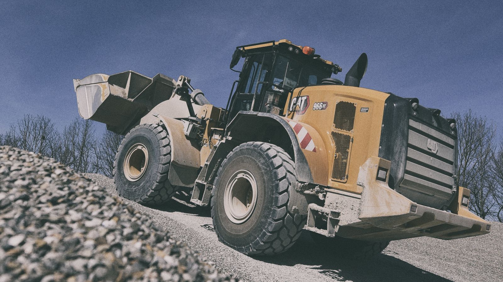 966 XE Wheel Loader transporting dirt on jobsite