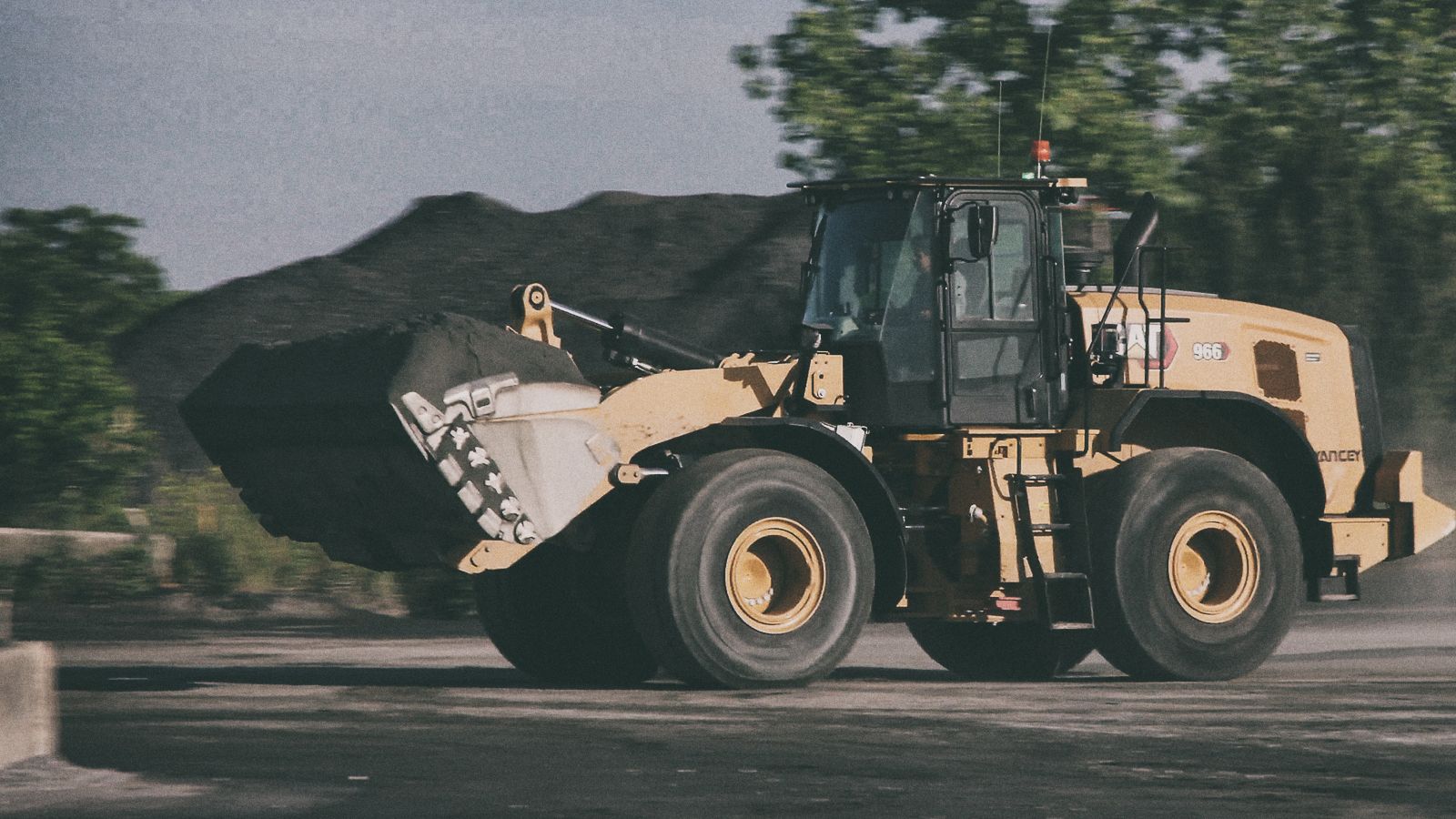 966 Wheel Loader transporting dirt on jobsite