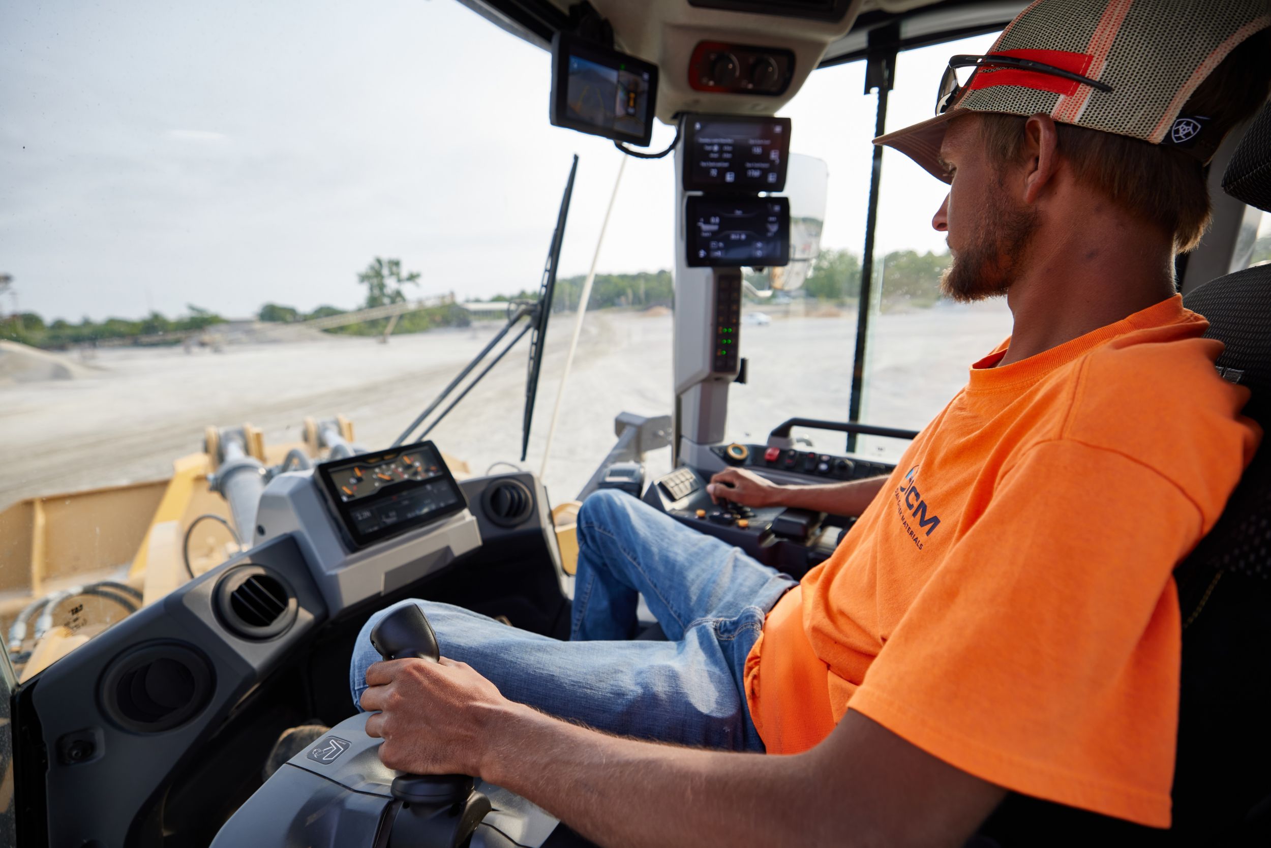 Man operating with joystick in cab