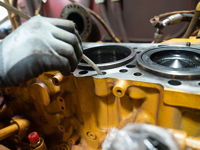 Technician working on an engine block