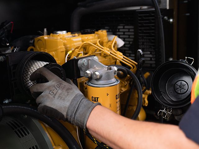Closeup of someone working on a Cat engine