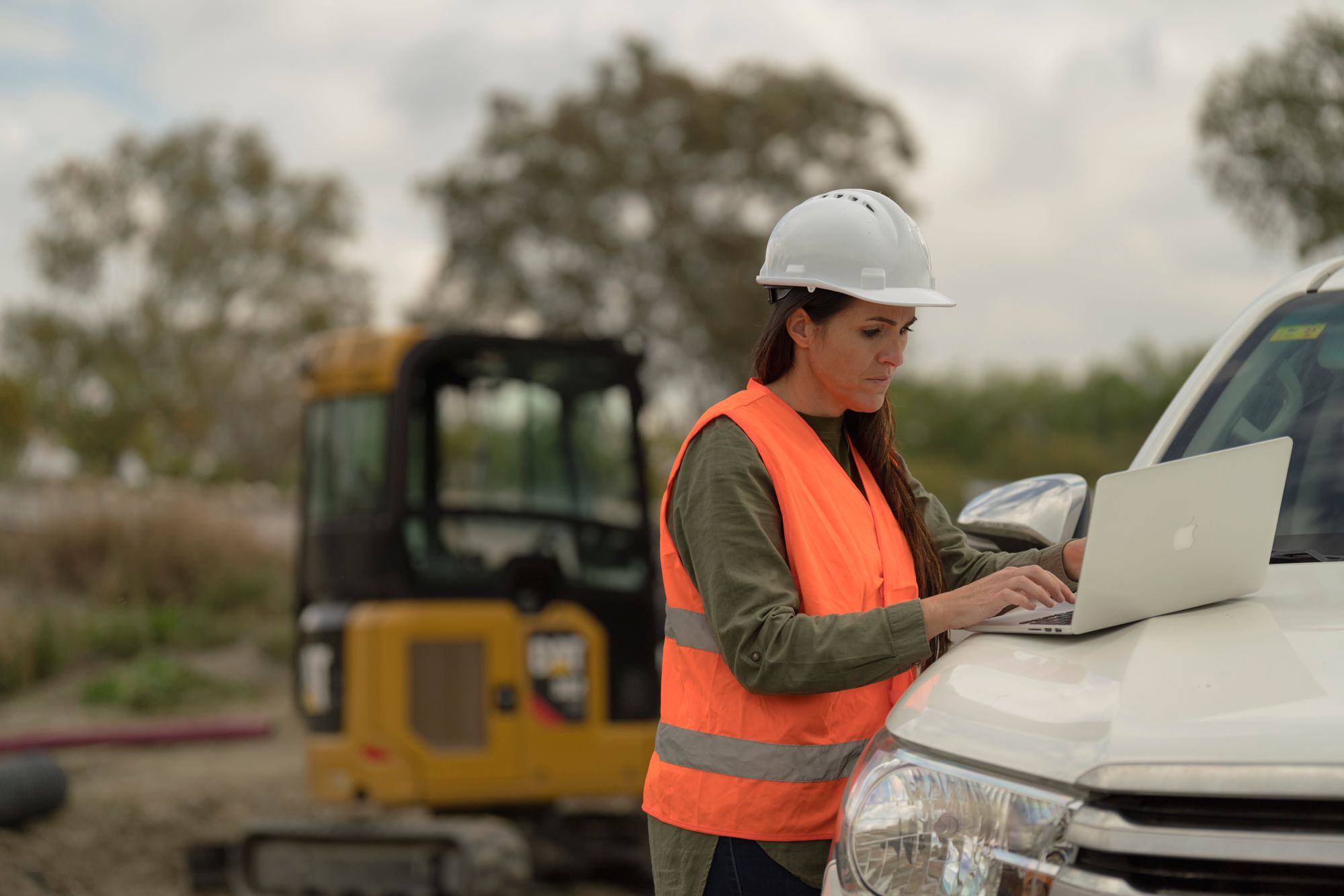 Woman on laptop in hardhat