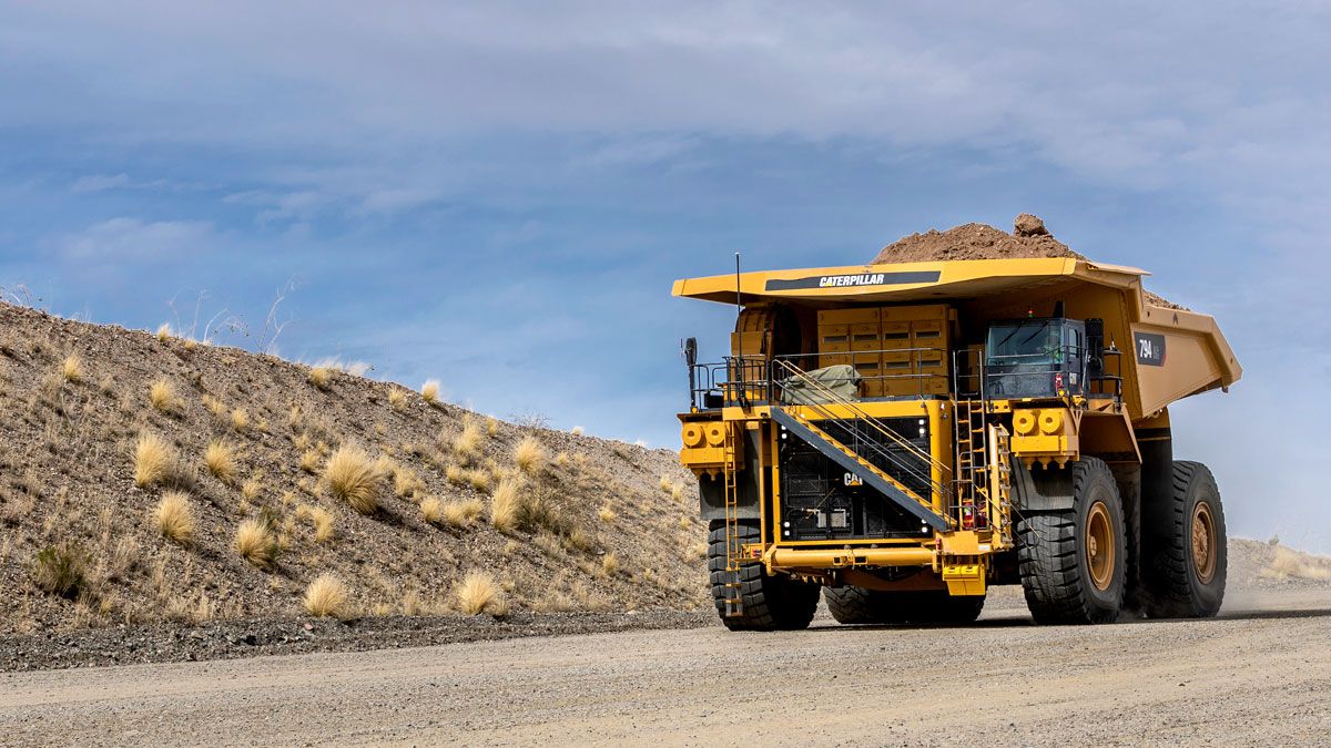Cat Mining Truck driving down dirt road