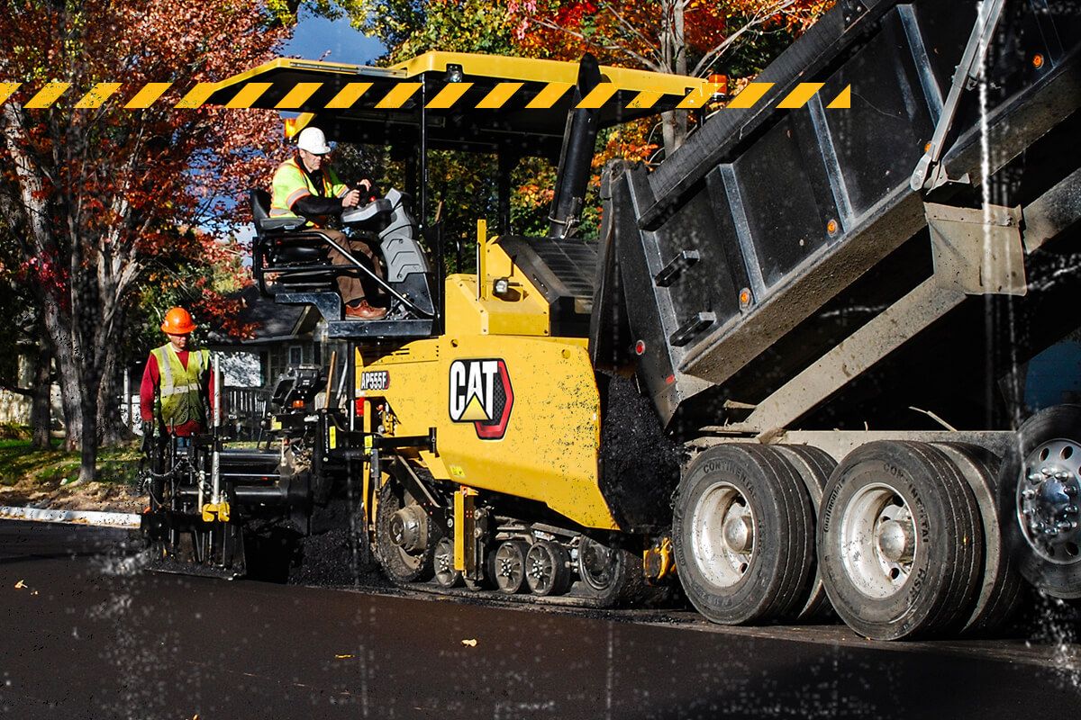 Paving machine being refilled with pavement material