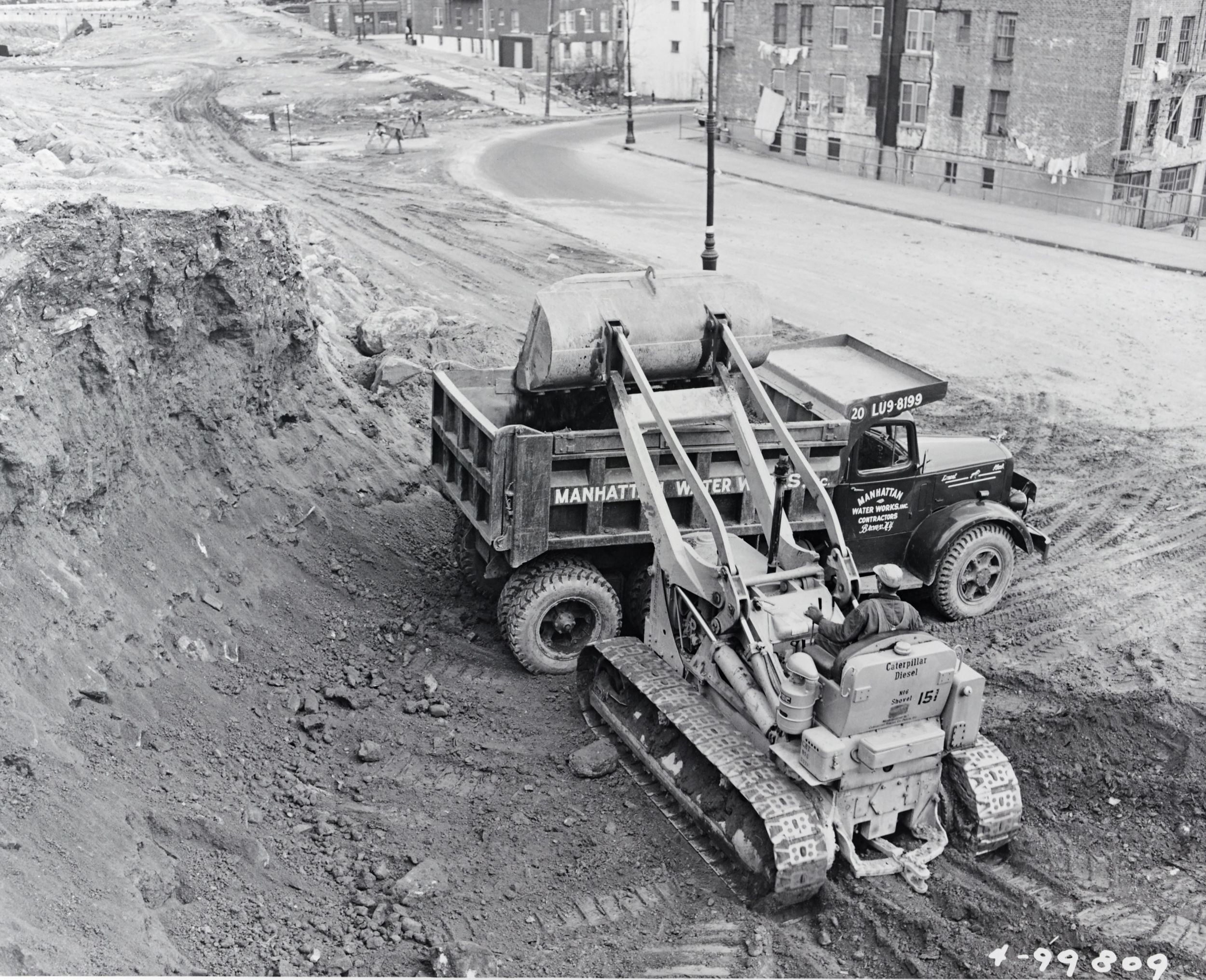 No. 6 Traxcavator loads dirt into a truck at a gravel pit in Arlington Heights, Illinois (circa 1953).