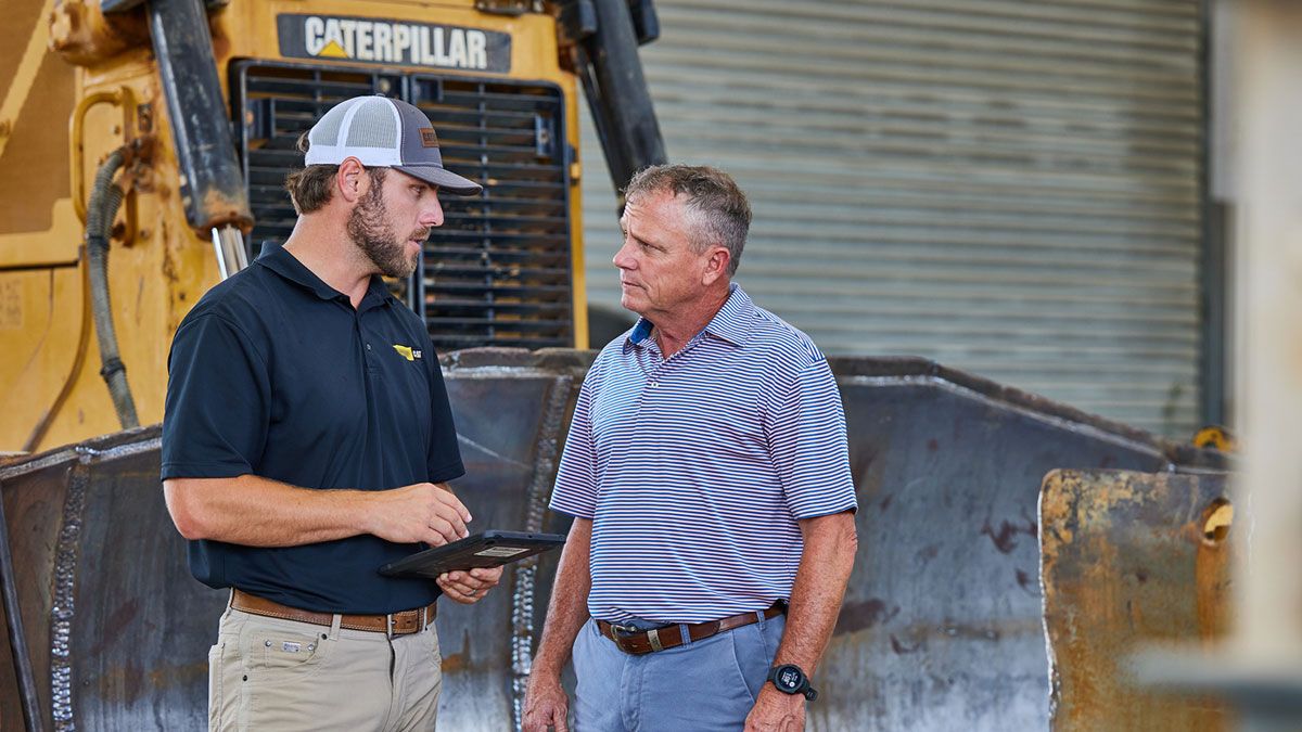 Cat dealer talking to customer
