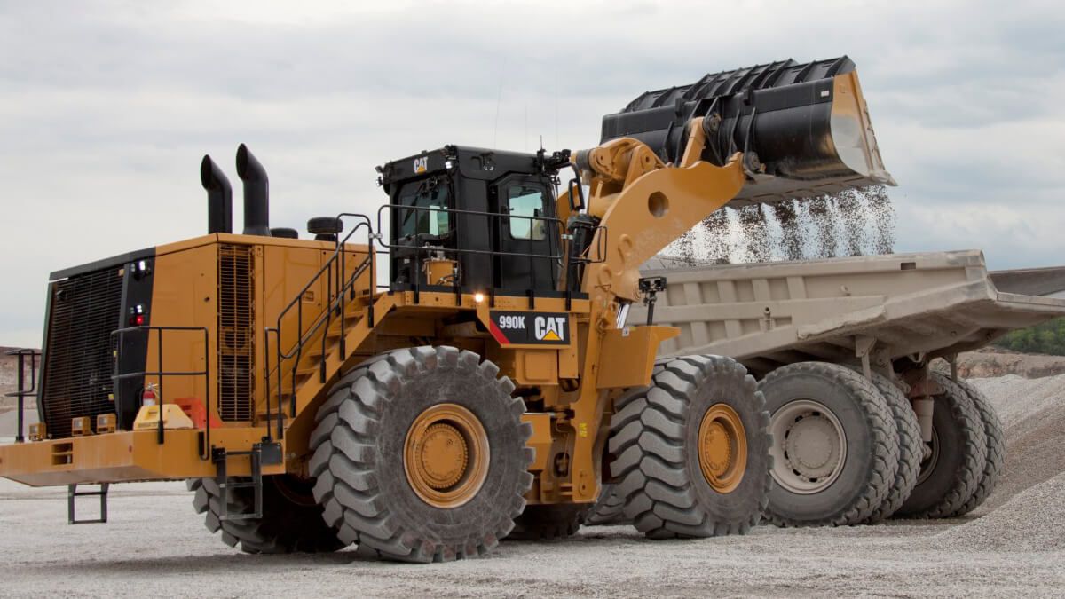 Large Wheel loader unloading dirt into Mining Truck