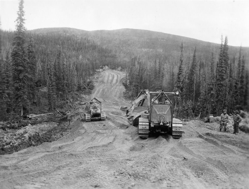 historic photo showing two Caterpillar machines in wilderness 