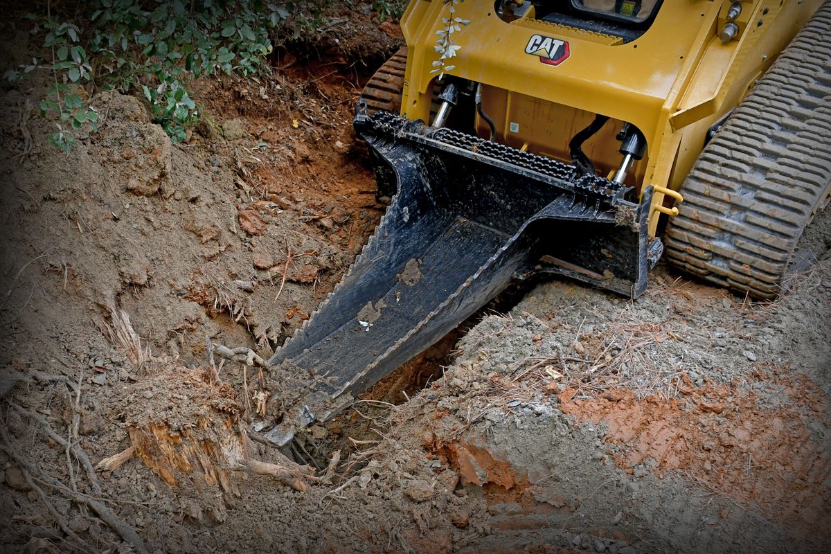 Available now, the new Cat® Stump Bucket attachment makes yanking stumps smooth as butter.