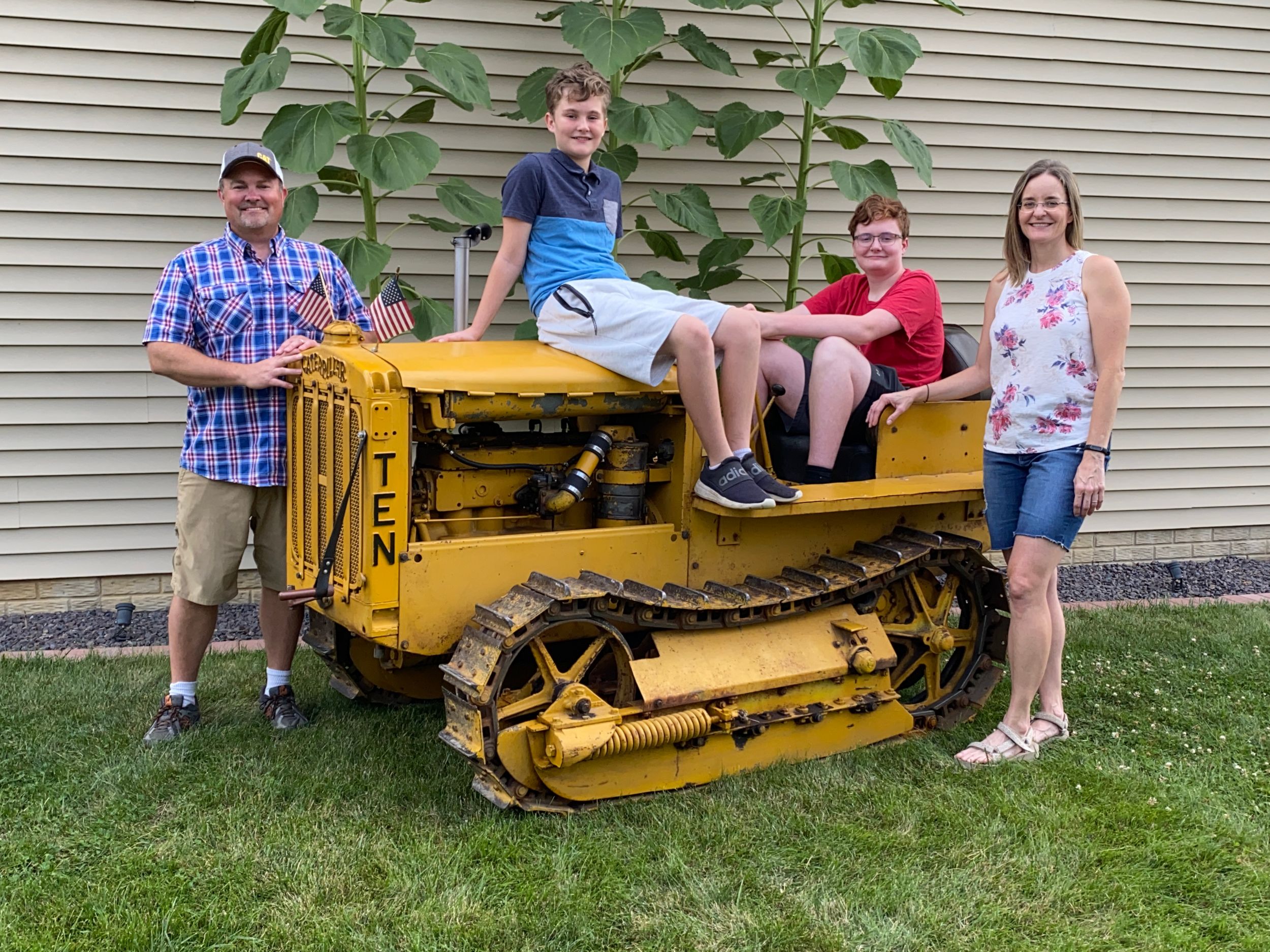 Dave Tallon and his family pose with their antique Cat Ten