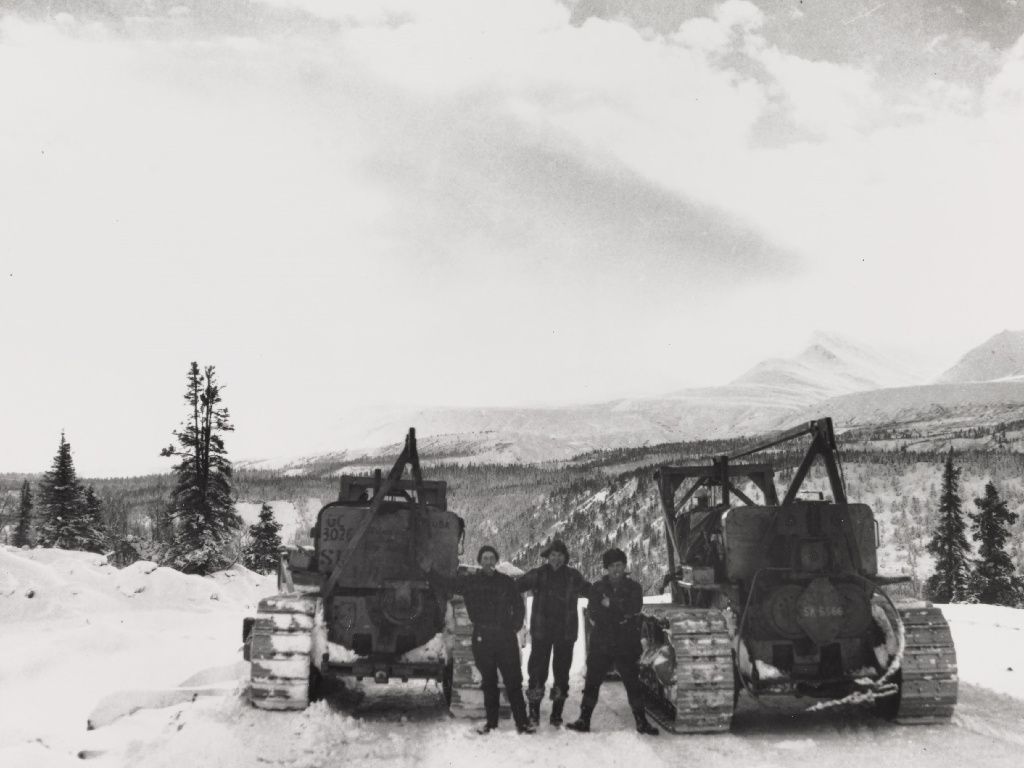 historic photo of two Caterpillar tractors during road construction 