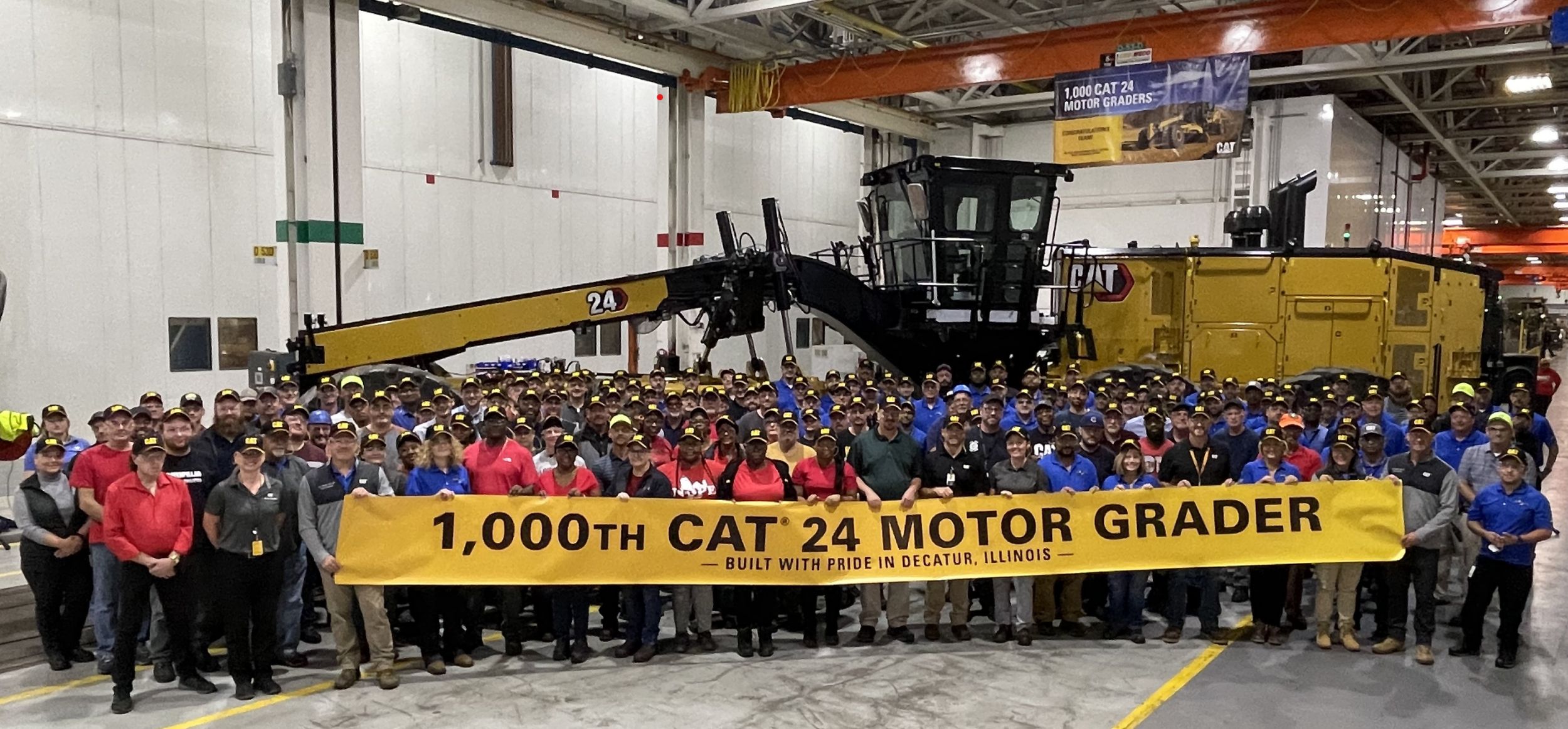 Production team celebrates the 1,000th 24 motor grader