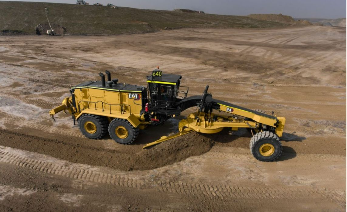 Motor grader pushing dirt