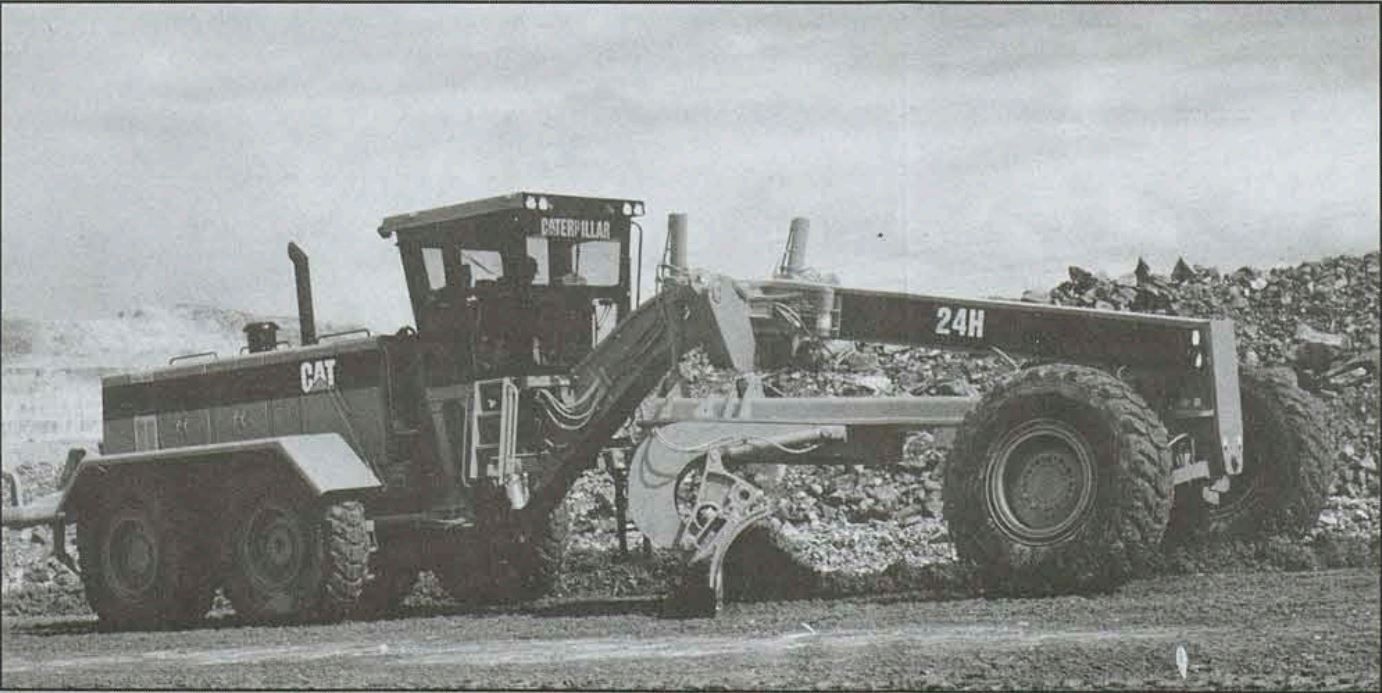 Black and white photo of a motor grader