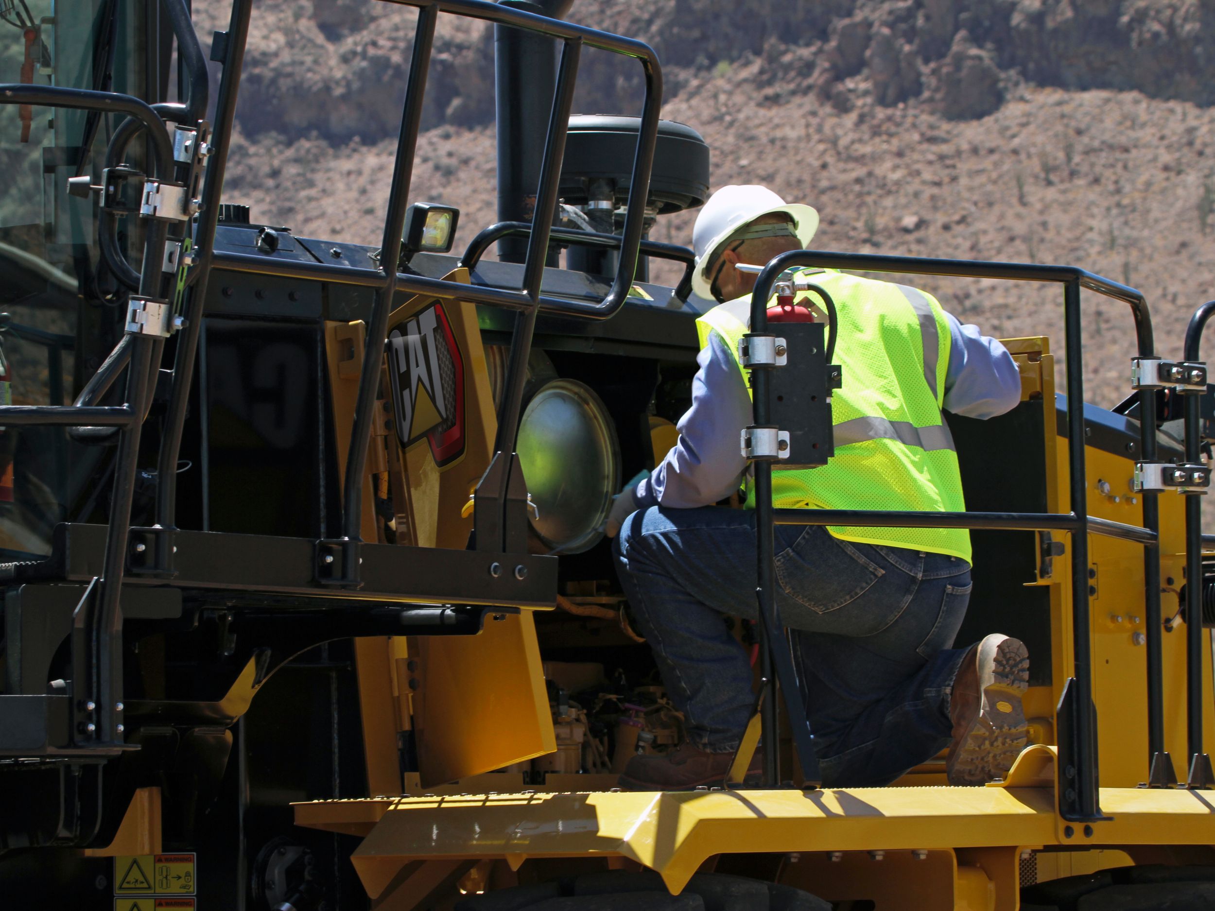 Inspecting 16 Motor Grader engine and filters