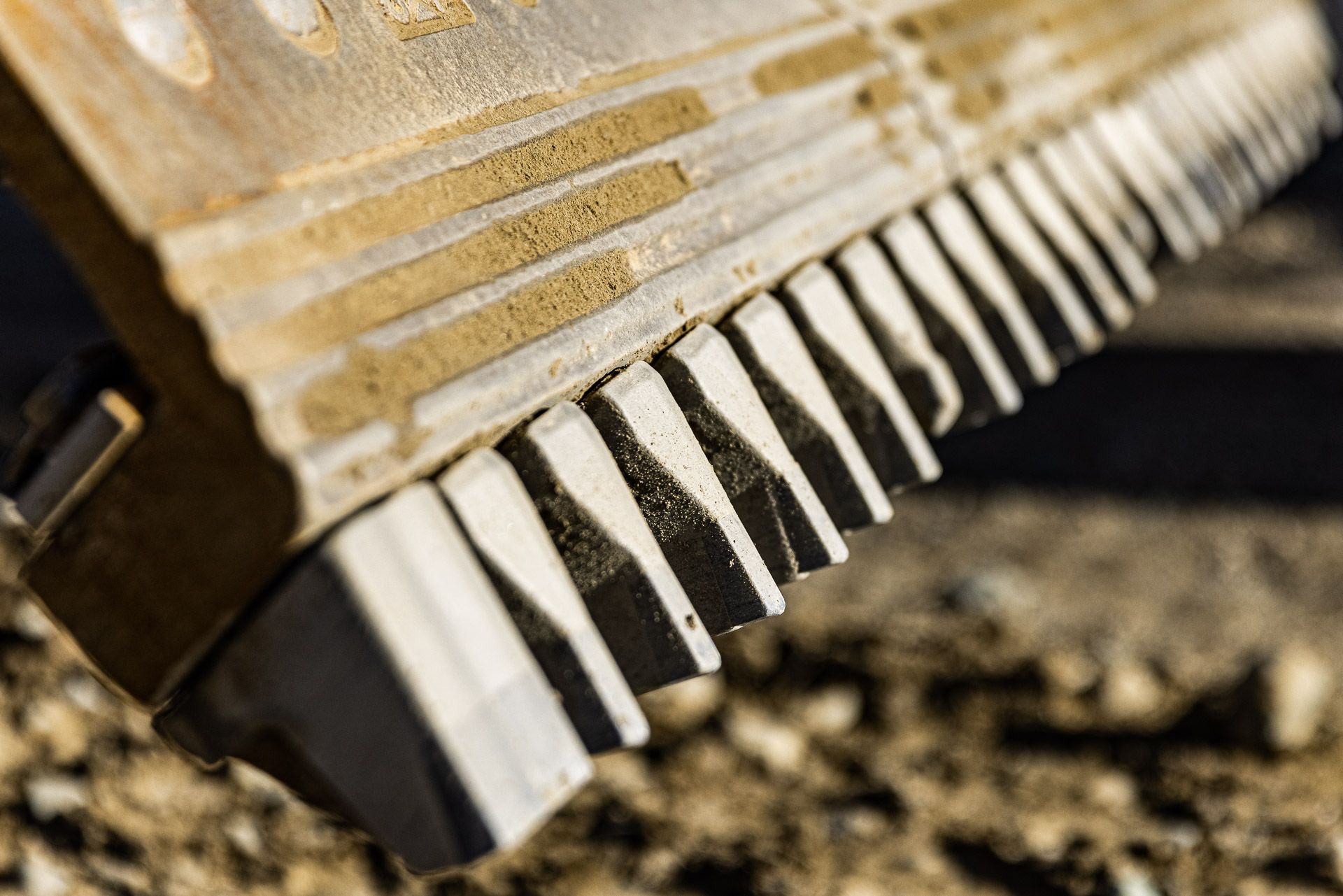 Close up of cutting edge bits on motorgrader blade