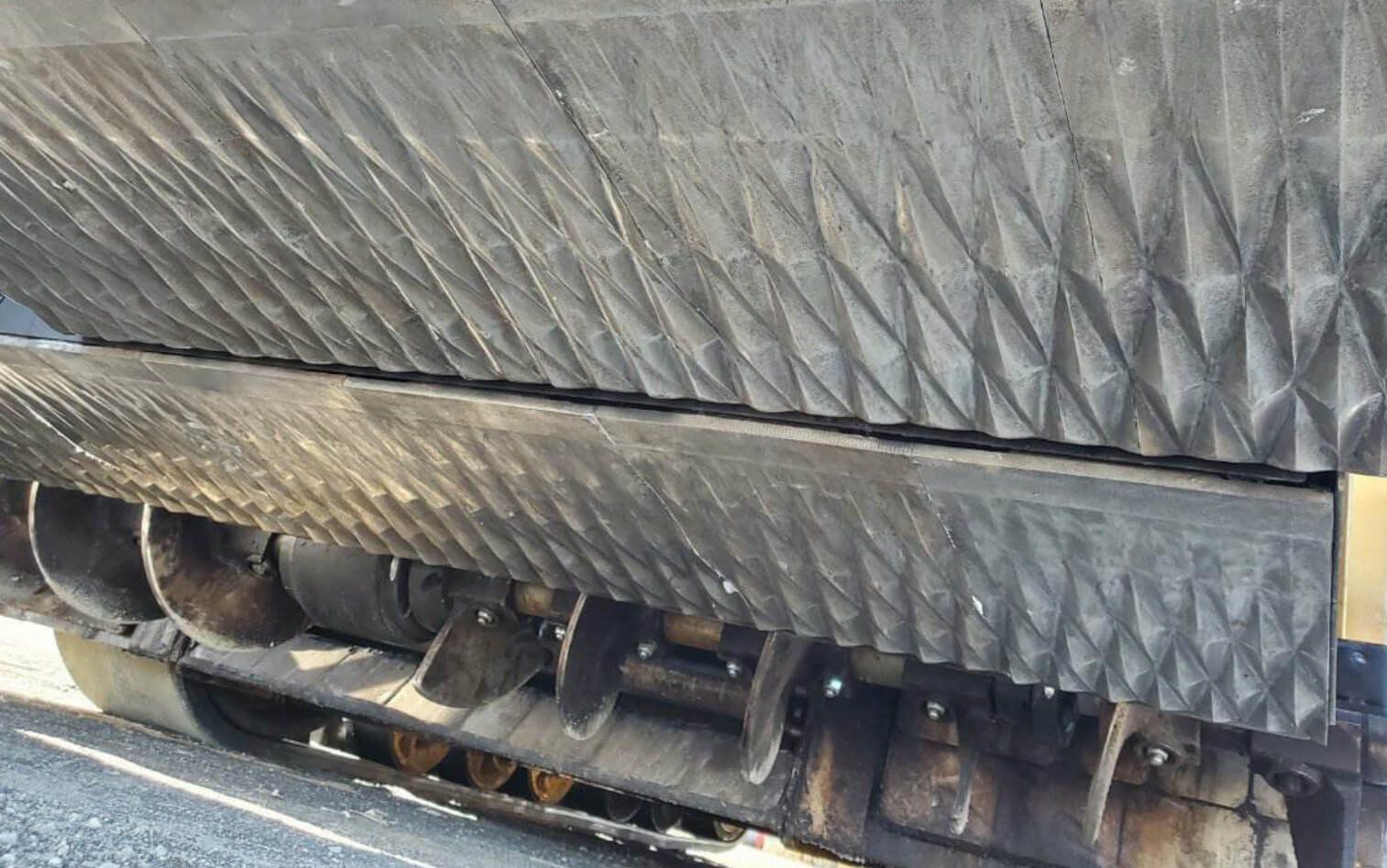 Paving machine being refilled with pavement material