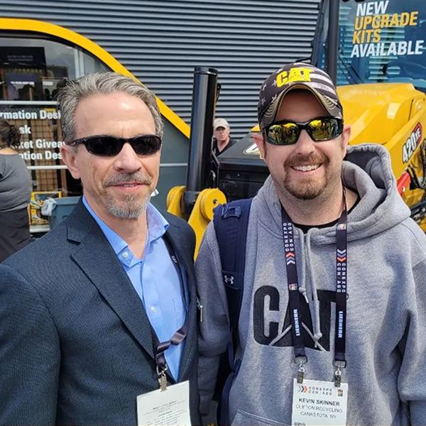 Show attendee poses with Caterpillar CEO Jim Umpleby