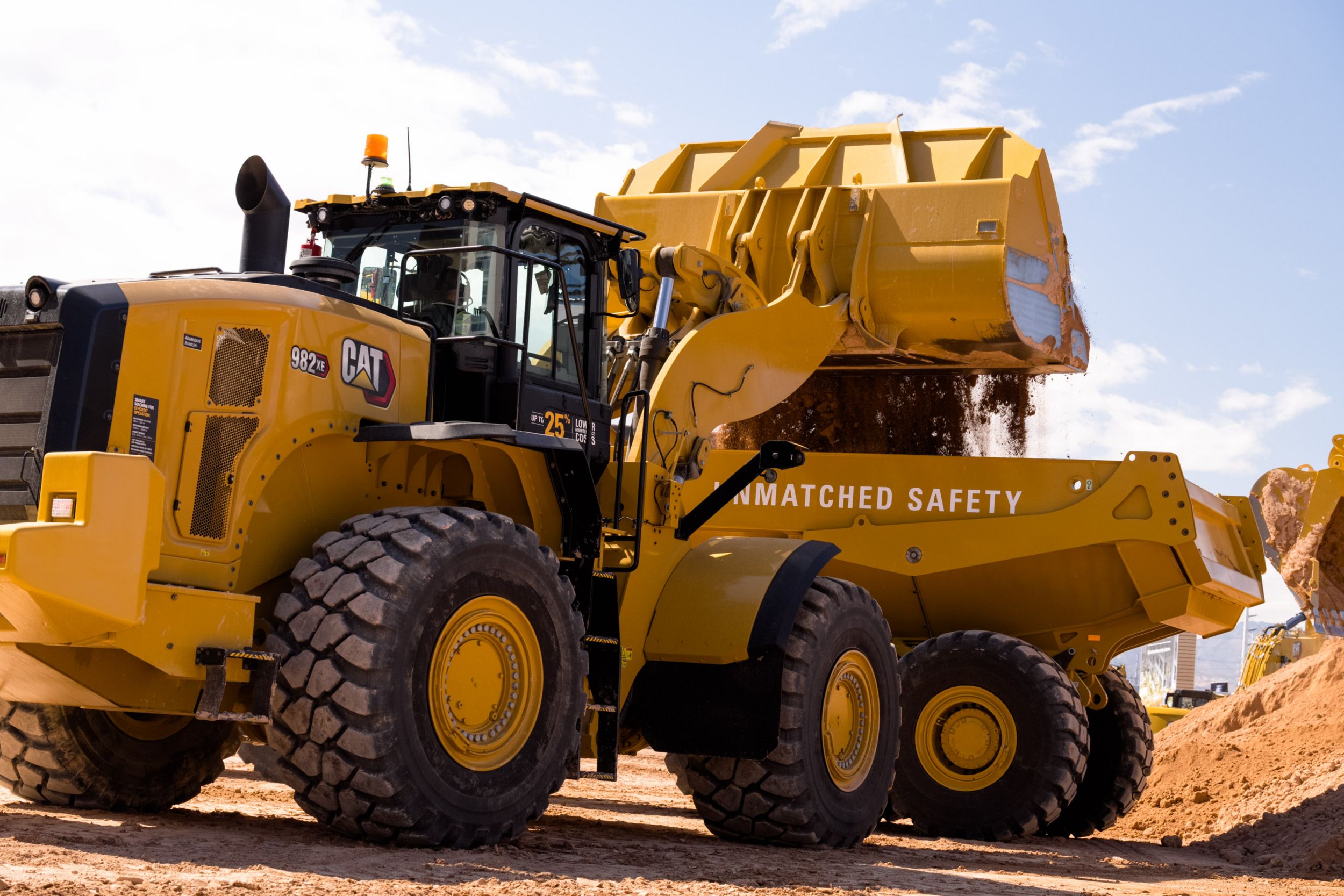 982 XE wheeloader loads an articulate truck within Operator Stadium