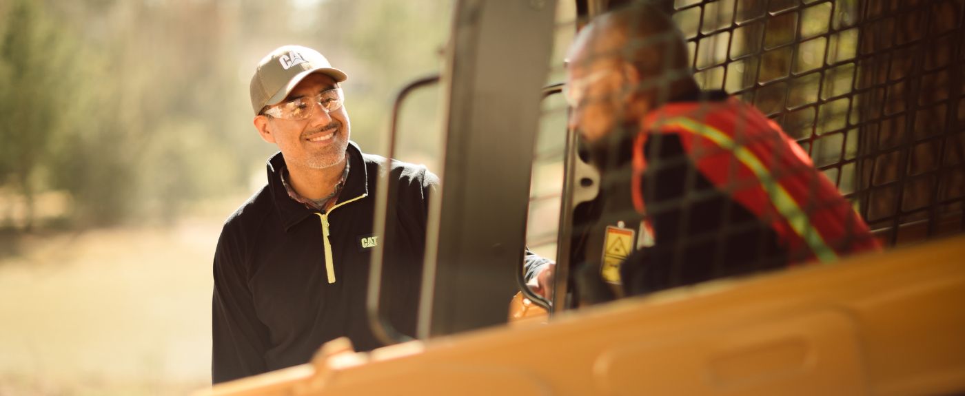 Customer operating machinery while talking to dealer