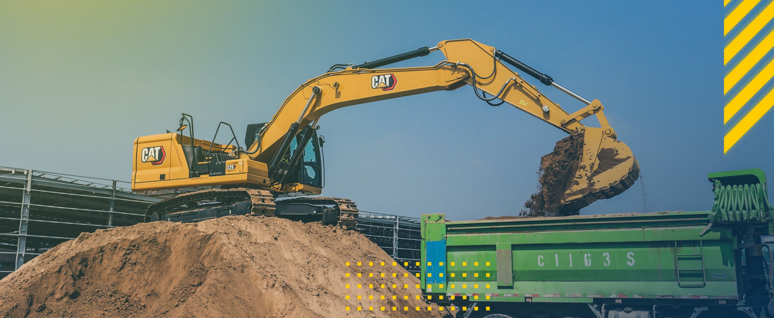 Excavator loading a truck on a job site