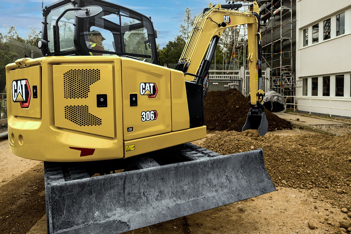306 Mini Excavator on jobsite scooping dirt