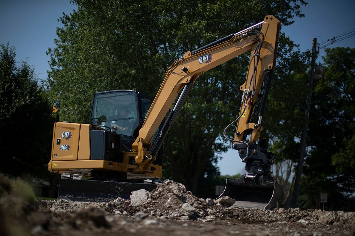 Cat mini excavator with bucket attachment