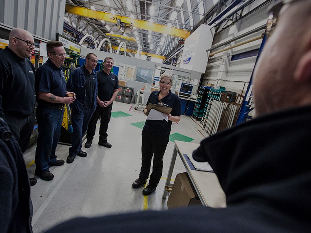 People having a meeting in Perkins manufacturing facility