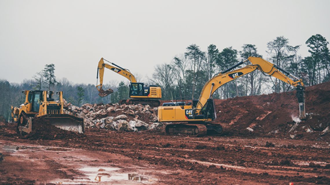 Three tractors working on a jobsite - Jobsite Overview