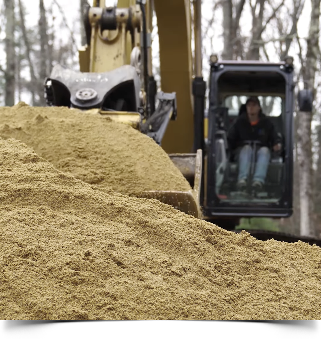 Tom digging in the dirt with excavator