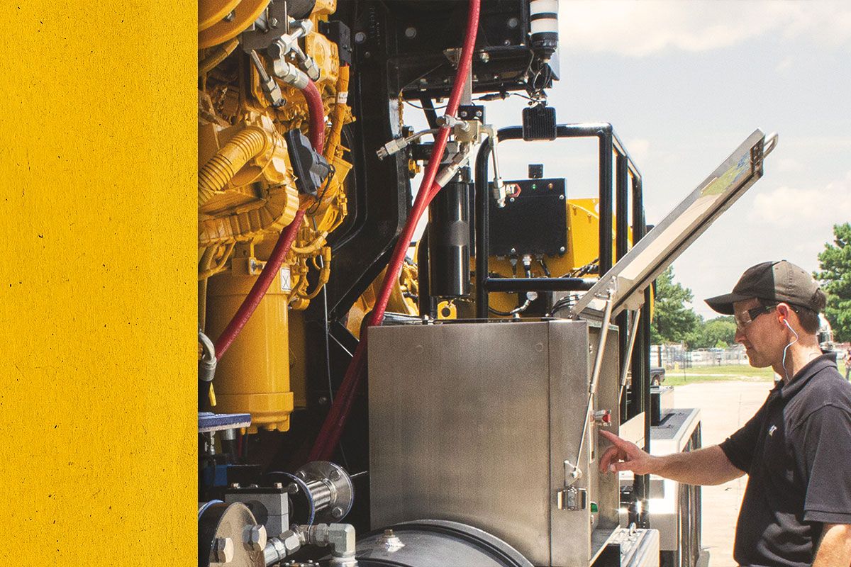 Close up of Cat worker checking the control panel of a Cat Engine