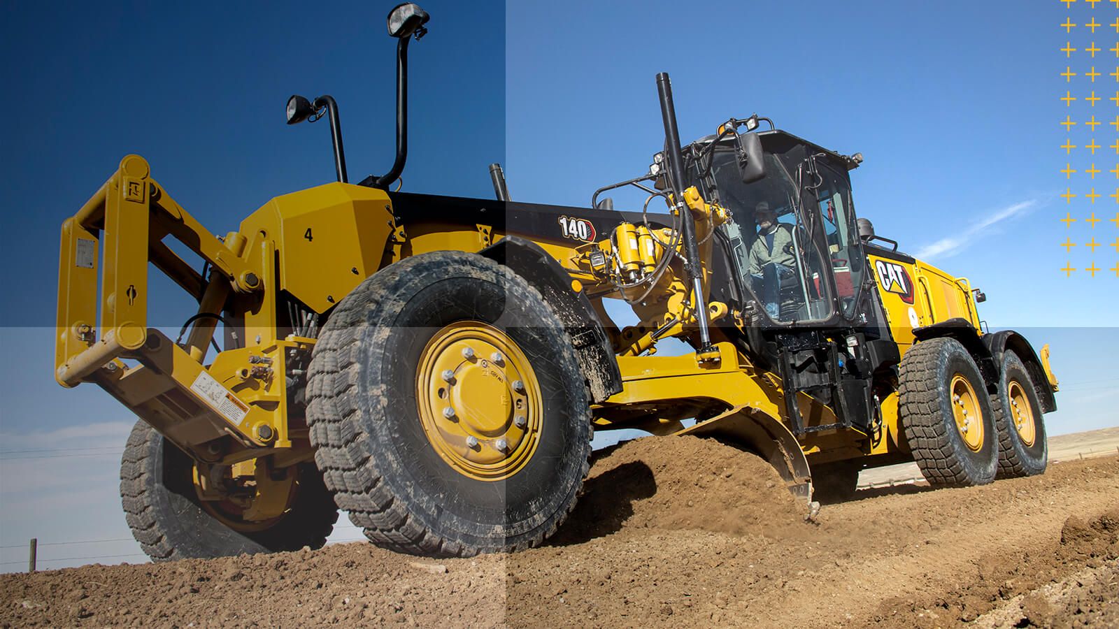 Motor grader pushing dirt with clouds in the background
