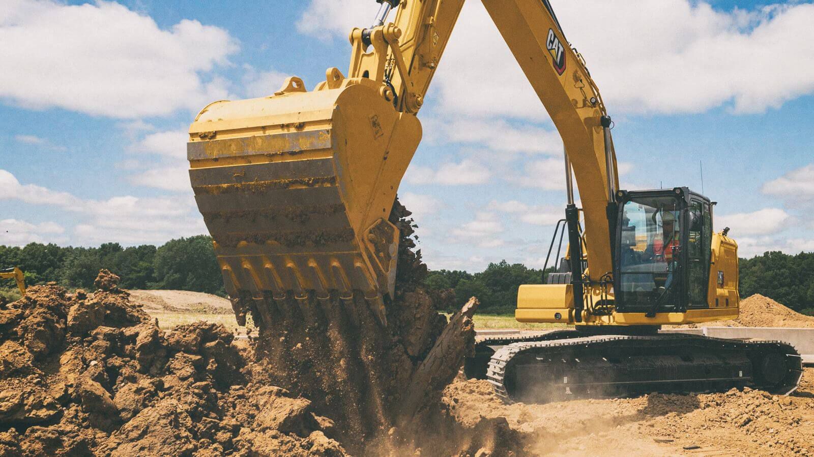 Excavator dumping dirt on a jobsite