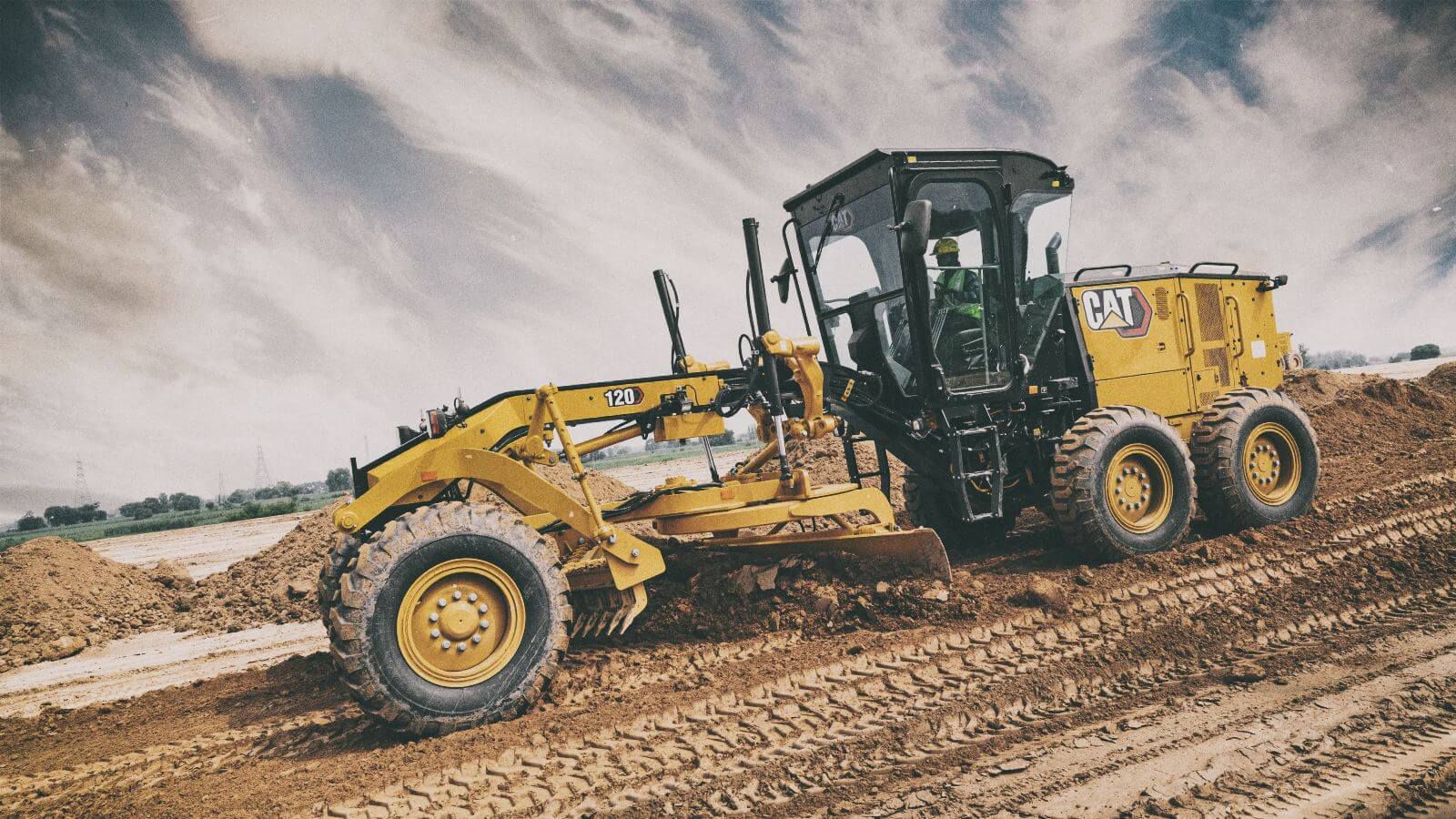 Motor grader pushing dirt on jobsite