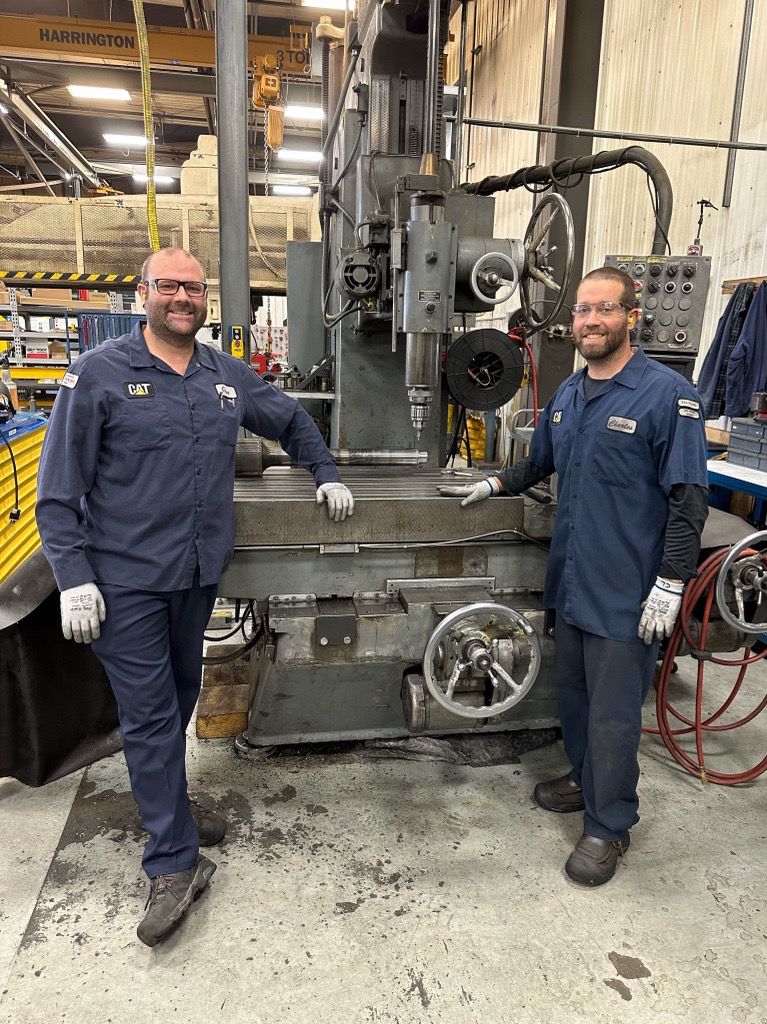 Reman employees in front of machinery